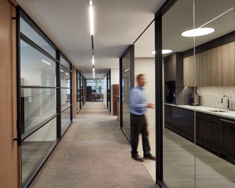Executive Offices are set around the perimeter of the space in a more traditional manner, while the use of glass breaks down barriers. Breaking up the corridor is the Executive Pantry which provides quick coffee service and refreshments.