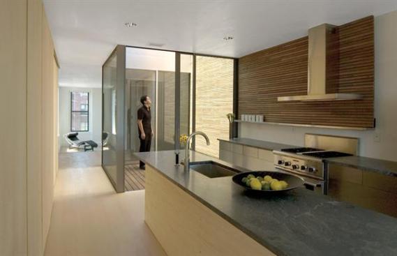 A circuit of lithe, airy living spaces wraps the edges of the newly combined apartments.