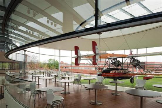 The balcony in Fortaleza Hall is at eye level with the Carna?ba. "You almost feel like you are floating up in the clouds with the plane," Robinson says. Designed as a part of the glass pavilion, the balcony serves as a bridge to The Commons and as one of the new building's four employee eateries. Giving those employees direct access to the plane was very important to company chairman and CEO and Sam's son, Fisk Johnson, as a means to engage them with his family's and the company's history. That history is detailed in a ground-floor gallery, which features artifacts from Sam Johnson's journey.