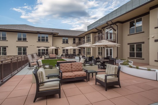 An outdoor space with furniture designed by studioSIX5 at Wind Crest Continuing Care Retirement Community in Highlands Ranch, Colorado.