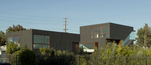 From the nursery, the two- and three-story volumes rise above the single-level homes in the neighborhood.