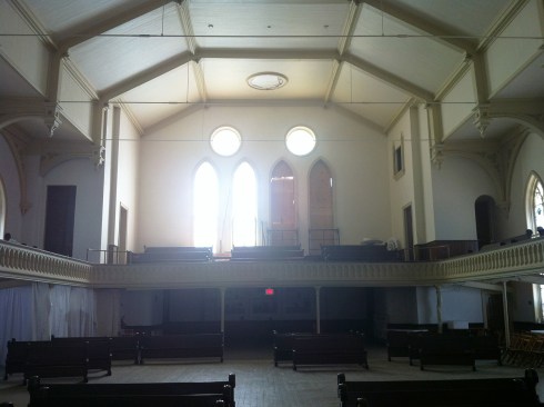 View of the Great Hall looking south. The program required that the space remain flexible for various types of events, but at least 700 seats were required. The south balcony was moved forward one bay so that retractable seating could be added below the balcony and new tiered seating be installed above the balcony. This also provided an accessible route from the elevator.