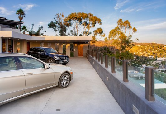Los Tilos modern home with Hollywood Hills views from outdoor terrace seating.