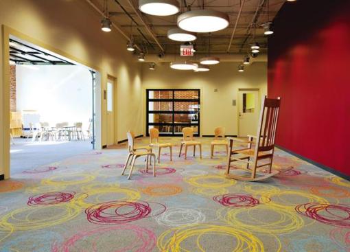 Spanish Education Development Center Rolling garage doors separate the classrooms from the main play area (pictured). With all the doors opened, the combined space can be used to host events.