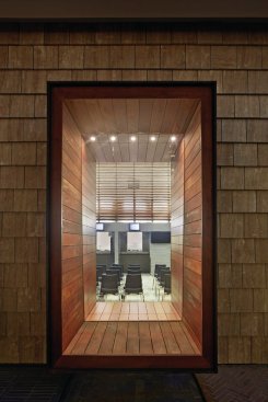 Wood and joinery moments are visible through punches in the exterior.