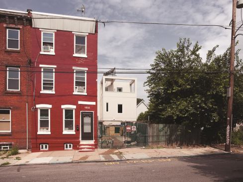 Historic row houses in the foreground frame a cluster of houses that ISA designed on Philadelphia’s Sheridan Street.