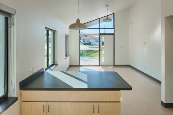 Armstrong vinyl composition tile runs throughout the house, shown here in the combined kitchen and living areas.
