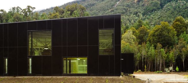 Cutouts from the façade allow outward views to the waterfall.