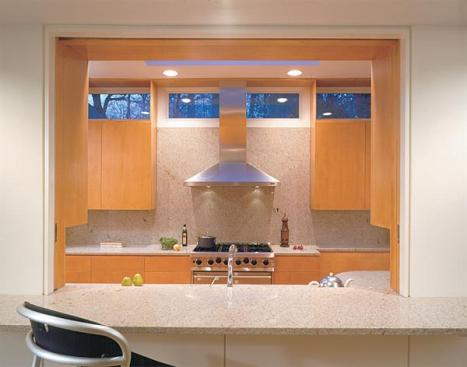 Custom maple cabinetry and a maple infill floor lend warmth.