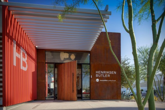 Perforated / repurposed weathered steel panels anchored six inches away from the building create an interesting shadow play / composition that highlights the entry corner further. 