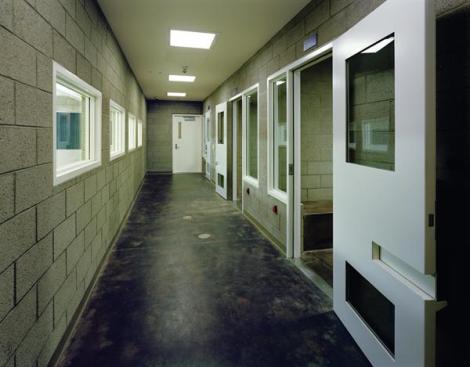 The holding cells are located in the booking area on the first floor. Here, in one of the few interior spaces that doesn't feature colored rubber flooring or natural light, security and durability are at a premium.