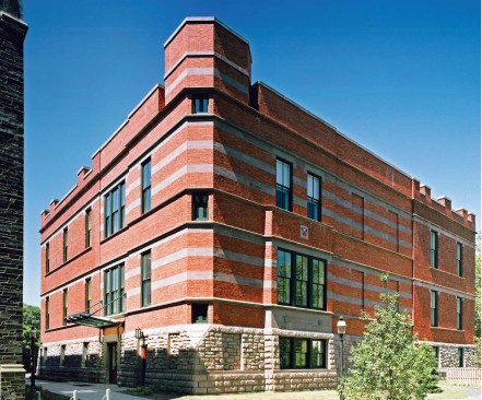 A 1940s two-story addition was demolished to make way for the new addition, which connects more uniformly with the existing Hunt building. The new addition carries through original details, such as the rusticated stone base, the brick coloration, and the coping from Hunt's chimneys (built to carry lab exhaust ), while introducing new design elements, such as the cast stone horizontal bands and the tower, meant to play off of the Collegiate Gothic style that dominates the rest of Princeton's campus.