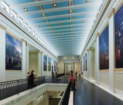 Natural light from the clerestory windows highlights the classical detailing, much of which was hand-painted. The space is open to the public, and it looks down onto the first-floor lobby corridor.