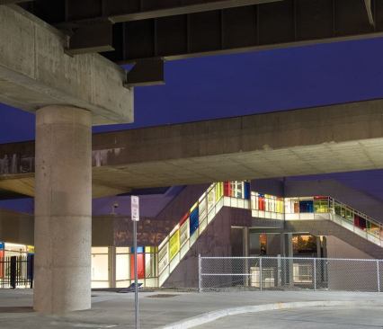 A skywalk on the building's southern end snakes up and over the Amtrak train tracks. Enclosed staircases lead passengers down to the platforms.