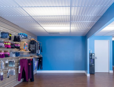 Non-exercise areas of the West LA studio, such as this merchandise room, feature luminous ceilings in another contemporary decorative style, Ceilume’s Southland pattern.