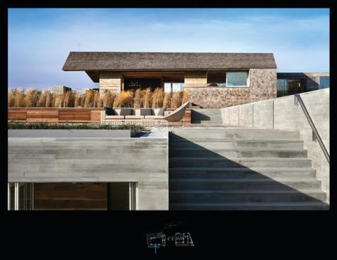 Sawn stone walls bring an appropriately raw sensibility to the seaside house.