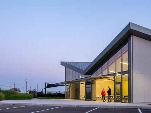 Two large awning doors allow for overflow to large patio area outside of Community Center. Patio has space for additional movable seats.
