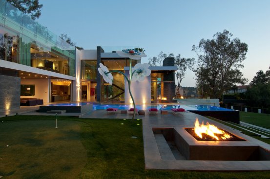 Beverly Hills home backyard outdoor entertaining area with swimming pool, artwork and fire pit.