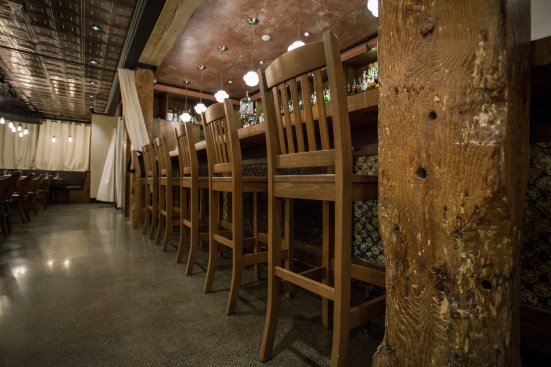 The solid cedar columns are original, and still bear scars from the wheels of wagons that used to pass through this former stable and shipping  facility.