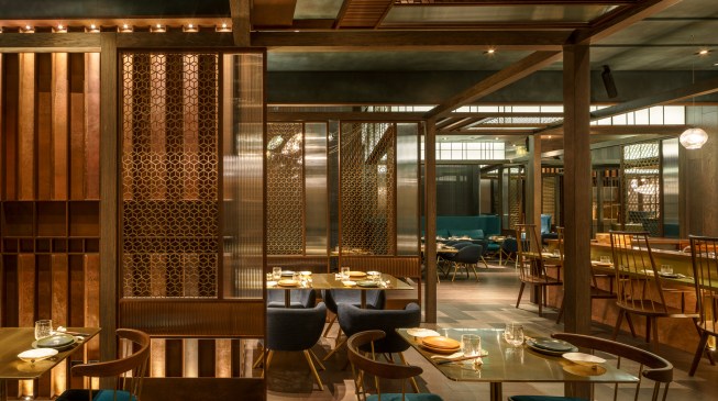 Traditional dining chairs swap wood spokes for brass, which complement the tables’ brass tops and legs. 