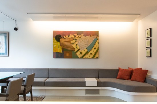 The custom built-in sofa was designed to house speakers. A custom 'light peel' fixtures was designed and fabricated, as we didn't have space for recessed lighting without lowering the ceilings heights, which we wanted to avoid.