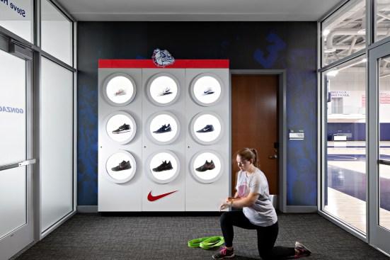 Student athletes are greeted by a dramatic Nike shoe display as they enter the weight training center.