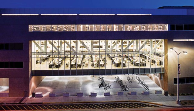 TRANSPARENCY Predock describes the building enclosure as "a big unapologetic wall that has apertures that allow different possibilities." The expanses of glazing allow passersby on the south or north sides of the building to see the activity in what is often a 24-hour building. The openings also allow students to look out, which Predock notes is something "that people in these studios need to, but don't often, do." His client is pleased. "The building responds even beyond my expectations," Schluntz says. "The school and our programs went from virtual obscurity to being the prominent feature on this segment of the campus."