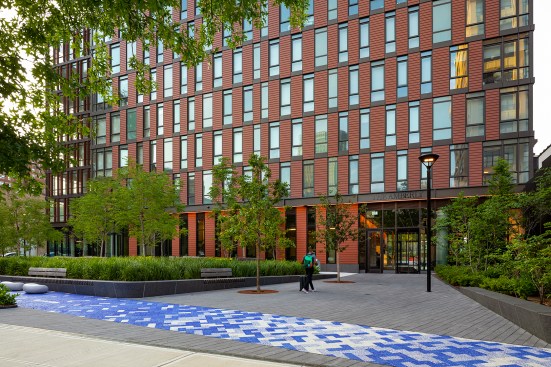 The south entrance is through a lush public plaza
