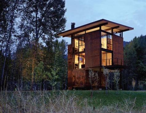 Flood-proof and virtually indestructible, this steeland-concrete cabin perches on the floodplain of a 43-acre site. Its shielded with huge steel shutters that can be closed with a handwheel when the owners leave (top left).