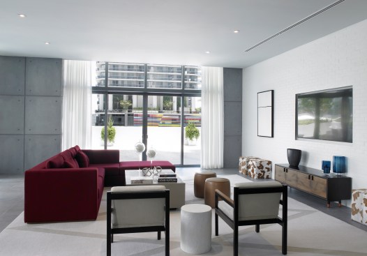 Designed with urban, cool neutral materials, the interiors serve as a gallery and backdrop for bold, artistic elements and reflects the sophisticated, modern living that the residential building provides.