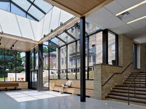 Stairway and seating in the new entry. Glass adds to the light, modern feel of this addition while offering views of the castle.