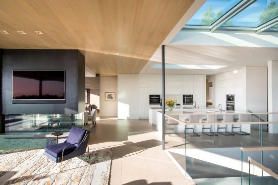 Modern open plan Beverly Hills home full of natural light through skylights and glass walls.