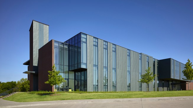 The east facade’s zinc cladding creates a skin that undulates and changes as it reflects interior functions. The south east corner begins to show the transition from “Now” to “Then” and highlights a light filled student space under the stair.