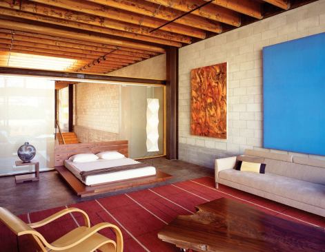 Sliding sandblasted glass doors in the living quarter borrow atrium light and views.