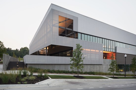 The east building is clad in perforated aluminum. A stair from the parking lot leads to a second-floor food hall, which will serve as an incubator for local restaurateurs and the new home of an enduring local soul-food staple: Big Mama’s Kitchen.