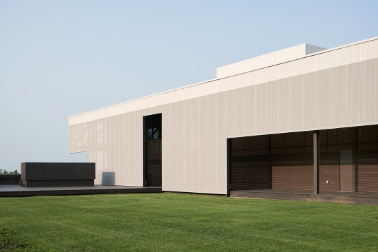 A perforated, corrugated metal scrim limits heat gain into the educational and incubator spaces within. Each institution in the accelerator has it own door and entry, connecting hem directly to the community.