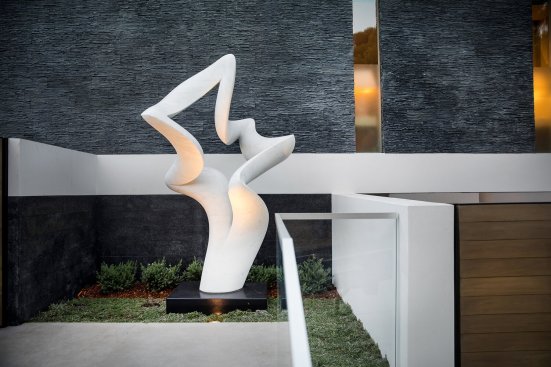 Luxury custom modern home entrance in Beverly Hills with Richard Erdman sculpture.