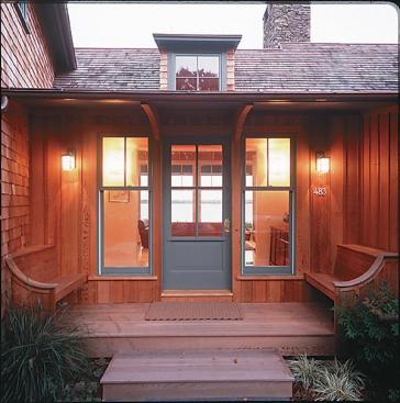 A rustic stone fireplace anchors the homes public rooms. Plentiful windows and a deck exploit views of the water. For the front entry, architect James Estes turned downthe volume, designing a low slung, welcoming inglenook