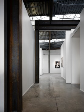 Your+first+view+as+you+enter+the+gallery+from+the+Pizza+Foundation+looking+south.++Notice+the+6%e2%80%99+wide+sliding+doors+that+create+security+between+the+spaces.+The+exposed+steel+is+waxed+to+prevent+rusting.++