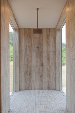 The temperature of the walk-in shower can be adjusted using the Indigo Personal Assistant App from your smart phone