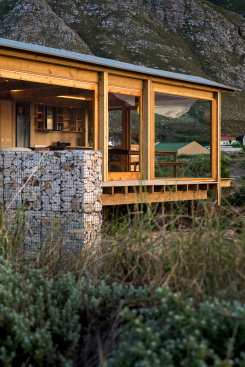 Juxtapositioning of the anchoring gabions against the timberwork. It’s a house of both sea and mountain