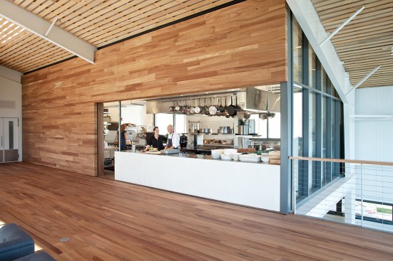 A+sliding+wall+(shown+here+in+the+open+position)+showcases+the+in-house+kitchen.