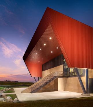 Boulder Regional Fire Training Facilities- Boulder, CO The 18,000-square-foot metal building is adjacent to the publically accessible Boulder Reservoir in Boulder County. The facility consists of a 10 acre fire training center including an administration building, burn building, drill tower and various training props. The sloping wedge form of the building rises from the bermed site perimeter to enclose higher volume spaces and second level classroom / observation hub, creating an iconic agrarian form respectful of its rural context.
Architect: Roth + Sheppard Architects/TCA Architecture Planning