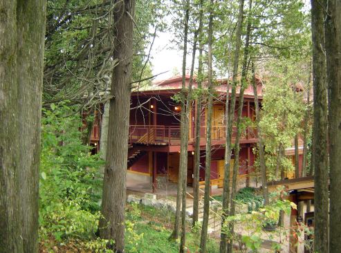 Peninsula Players Theatre-Fish Creek, Wisconsin In 1937 the newly vacated 22-acre Wildwood Boys Camp became the home of the Peninsula Players Theatre. It offers a truly beautiful and striking setting with its spectacular sunsets, cedar-scented landscape, paths along the Green Bay shoreline, and enchanting gardens. A unique working resident theater company was formed with more than 40 theater professionals living on property. By the late 1990s, the aging stagehouse began to show the need for significant renovations and repairs. It needed to maintain the tradition of natural acoustics and provide all the technical needs of a 21st century professional theater. 
Architect: Holabird & Root