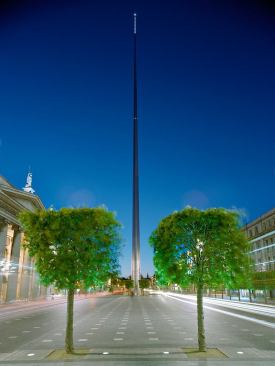 The Spire-Dublin, Ireland This tapering monument, 120 meters high and 3 meters in diameter at the base, rises above O'Connell Street, breaking above the roof line with as slender and elegant a movement as is technically possible. Its structure and surfaces respond to the character and climate of the Irish landscape: the Spire sways gently in the wind and, during the daytime, the monument softly reflects the light of Ireland's sky. From dusk, the base is gently lit and the tip illuminated to provide a beacon in the night sky over Dublin. The bronze base is flush with the surrounding paving, allowing individuals and groups to stand on the base to see themselves and touch the Spire surface. 
Architect: Ian Ritchie Architects