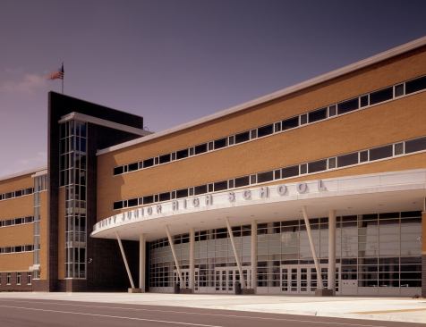 Unity Junior High Schoo-Cicero, Illinois The new 442,000-square foot junior high school is composed of two 1,800-student schools joined to share common spaces. The four-story building features academic spaces along a curved spine, a media center, and a large student commons. The school’s curved exterior fits the length of the building on the site and breaks up the long corridor into a shorter perceived length. On each end of the curve, glass-enclosed stair towers taper to a wedge, funneling natural light into the interior spaces during the day. At night, the towers appear as glowing beacons to the area's downtown. 
Architect: FGM Architects