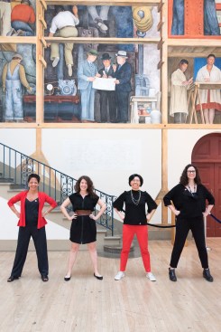 The 2018 Equity by Design core team (l to r) Lilian Asperin, Annelise Pitts, AIA, Rosa Sheng, and Julia Mandell stand in front of the Diego Rivera mural The Making of a Fresco Showing the Building of a City.
