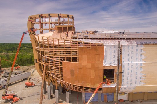 The replica structure comprises a series of timber cross frames, spaced 18 feet on center, that include two 18-inch-deep glulam ribs, which form the building's curved hull.