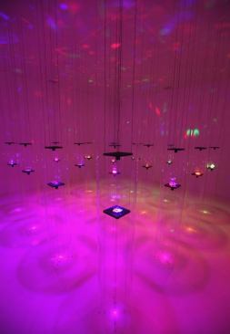Erwin Redl  Design Miami   In this psychedelic composition by Austrian artist Erwin Rdel, 16 disks dangle from the ceiling, each displaying a cluster of Swarovski crystals. Light from floating LEDs reflects and refracts off the jewels, creating an aesthetic somewhere between high art and discotheque.