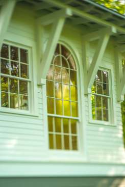 Salvaged materials, such as this Palladian church window, mix with new design features to create a modern space with nostalgic touches.